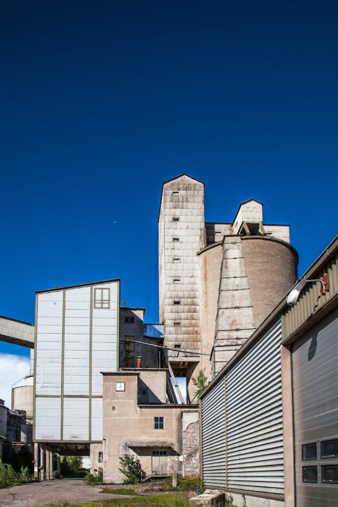 A tall industrial building with a clear blue sky above, showcasing architecture and industry.